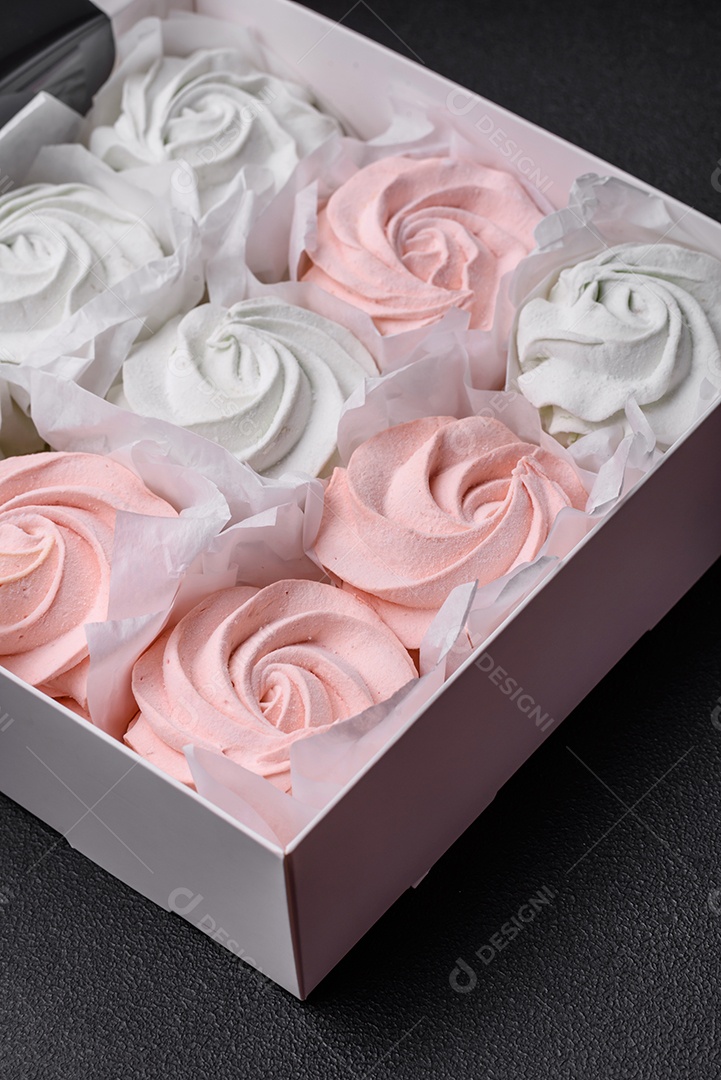 Delicioso marshmallow doce multicolorido em um fundo escuro de concreto. Doces saudáveis ​​para a mesa de jantar