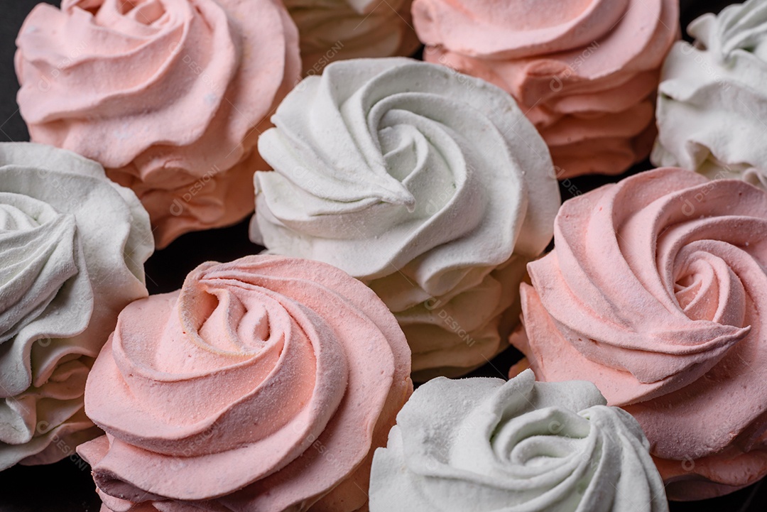 Delicioso marshmallow colorido doce em um fundo escuro de concreto. Doces saudáveis ​​para a mesa de jantar