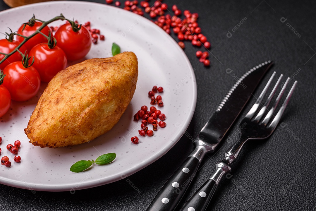 Deliciosa costeleta de batata assada recheada com frango e legumes, especiarias e sal sobre um fundo escuro de concreto