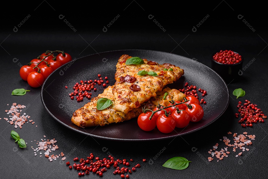 Deliciosa pizza de pão achatado fresco com queijo, tomate, salsicha, sal e especiarias sobre um fundo escuro de concreto