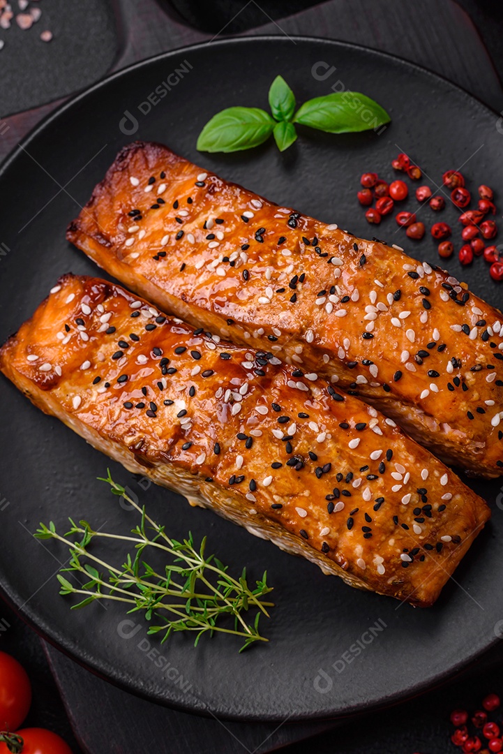 Delicioso peixe vermelho grelhado fresco com sal, especiarias e ervas sobre um fundo escuro de concreto