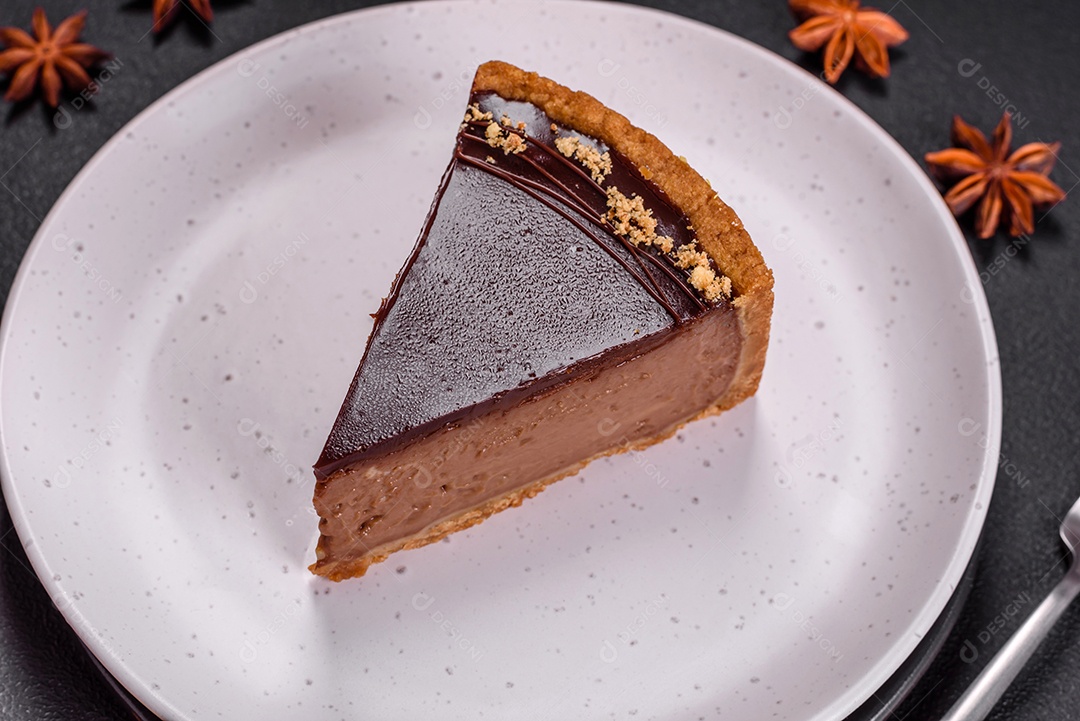 Rolo de merengue delicioso, fresco e doce com creme, lascas de amêndoa, nozes e frutas cortadas em fatias sobre um fundo escuro de concreto