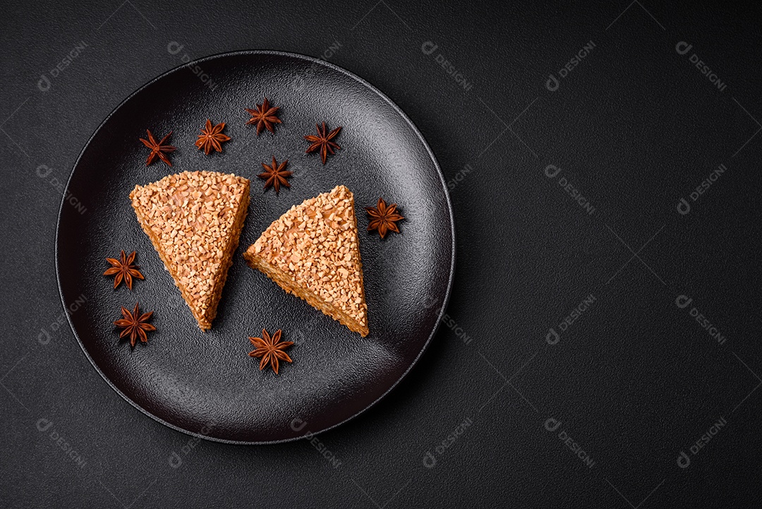 Delicioso bolo de waffle doce com creme e nozes cortados em pedaços sobre um fundo de concreto texturizado