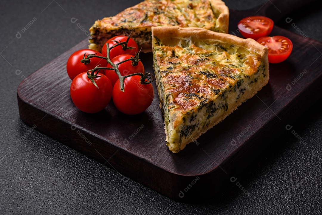 Deliciosa quiche fresca com brócolis, queijo, especiarias e ervas cortadas em pedaços sobre um fundo escuro de concreto
