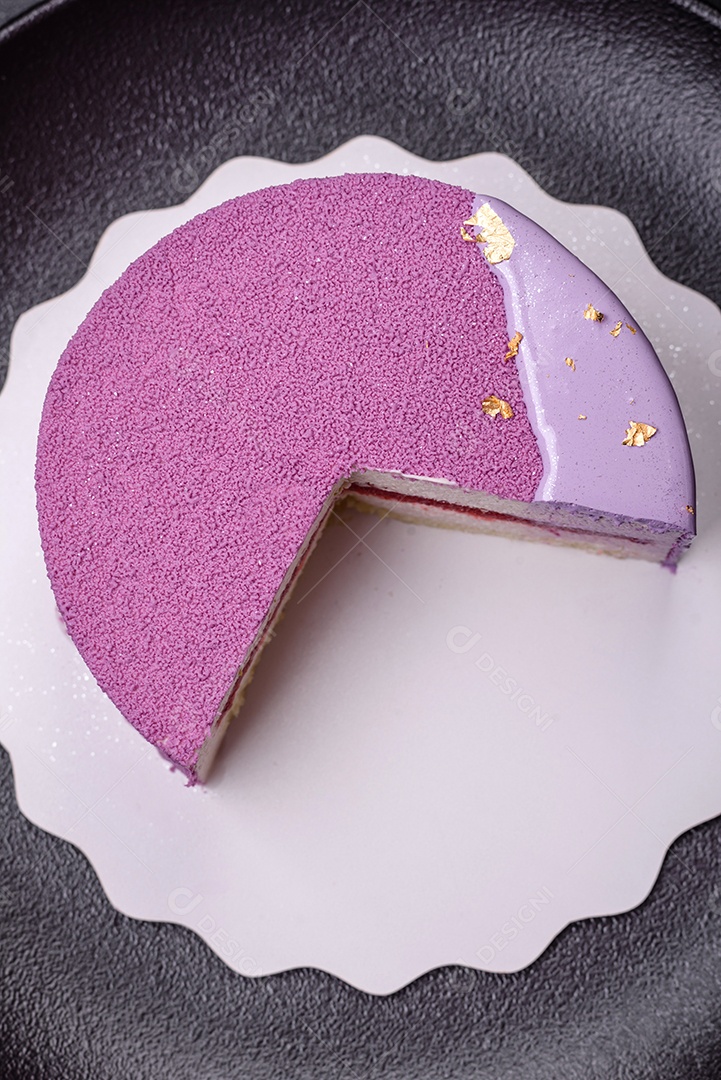 Delicioso bolo de mousse doce fresco com recheio de frutas vermelhas coberto com cobertura de veludo rosa sobre fundo escuro de concreto