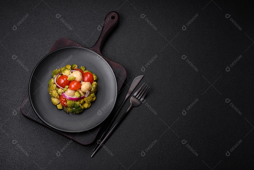 Deliciosa salada fresca de feijão verde, ervilha, pimentão e queijo com sal e especiarias sobre um fundo escuro de concreto