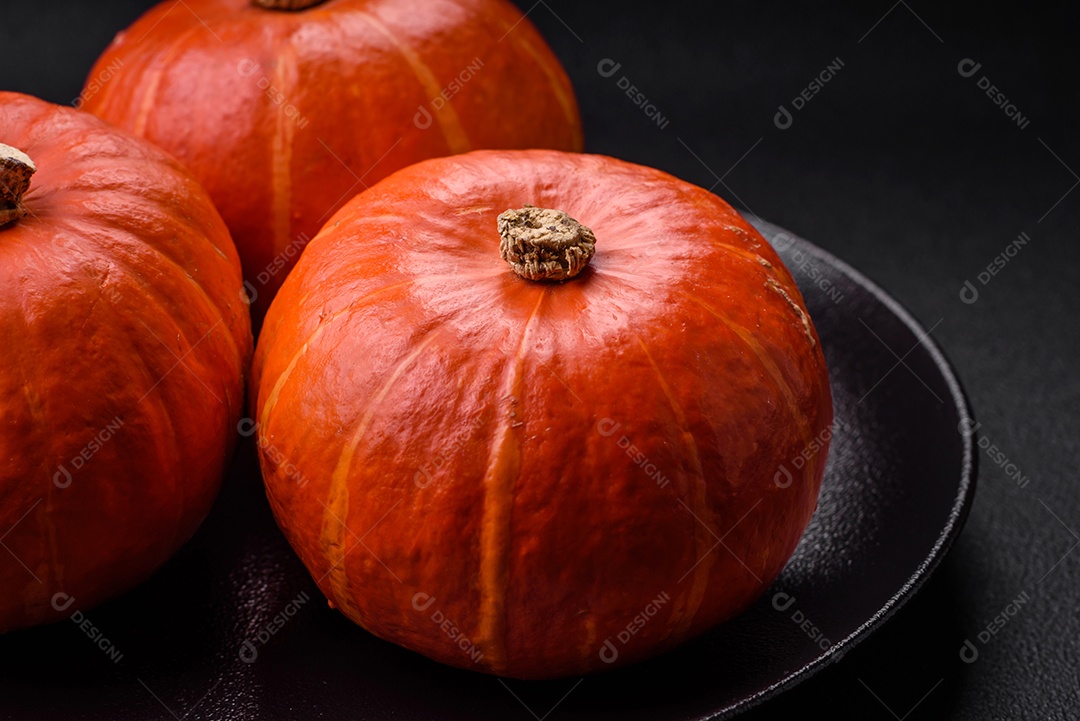 Lindas abóboras redondas frescas na cor laranja sobre um fundo escuro de concreto. Preparando-se para a celebração do Halloween