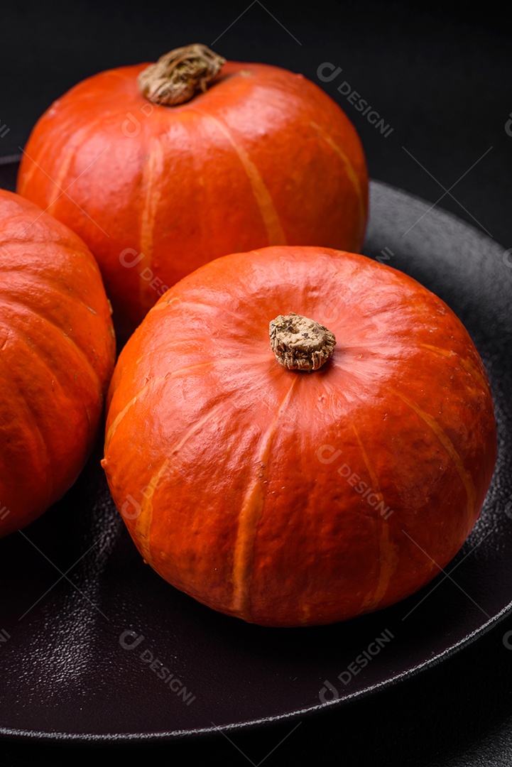 Lindas abóboras redondas frescas na cor laranja sobre um fundo escuro de concreto. Preparando-se para a celebração do Halloween