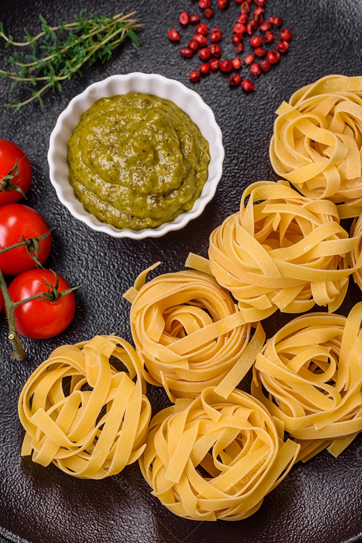 Delicioso molho vermelho picante com sal e especiarias em uma tigela de cerâmica sobre um fundo escuro de concreto