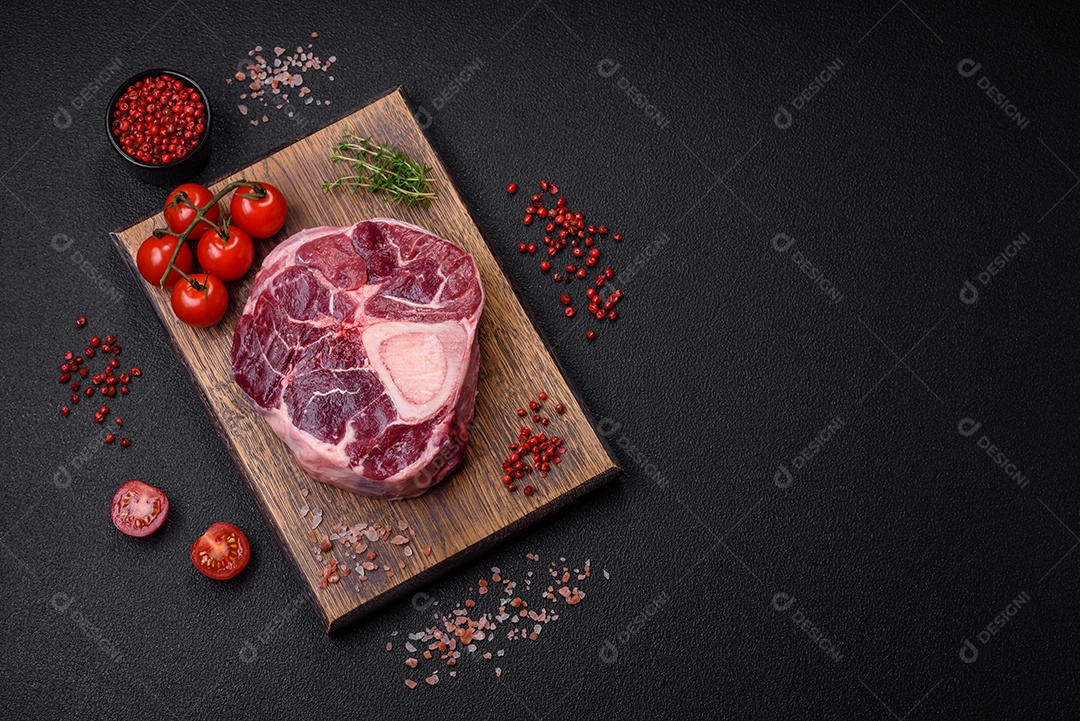 Bife de ossobuco de carne fresca com sal, especiarias e ervas em fundo de concreto texturizado