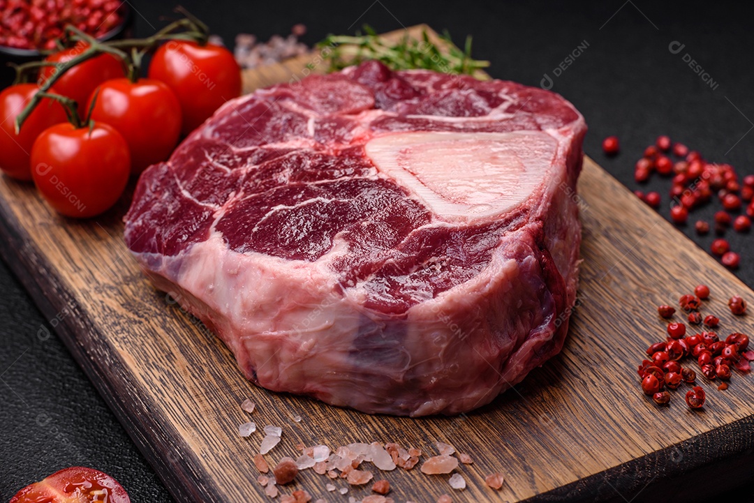 Bife de ossobuco de carne fresca com sal, especiarias e ervas em fundo de concreto texturizado