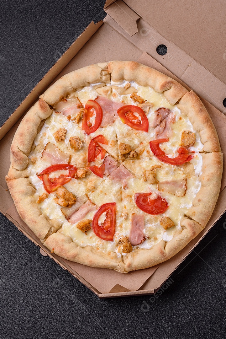 Deliciosa pizza quente com frango, tomate, queijo e bacon, com sal e especiarias e sobre fundo escuro de concreto