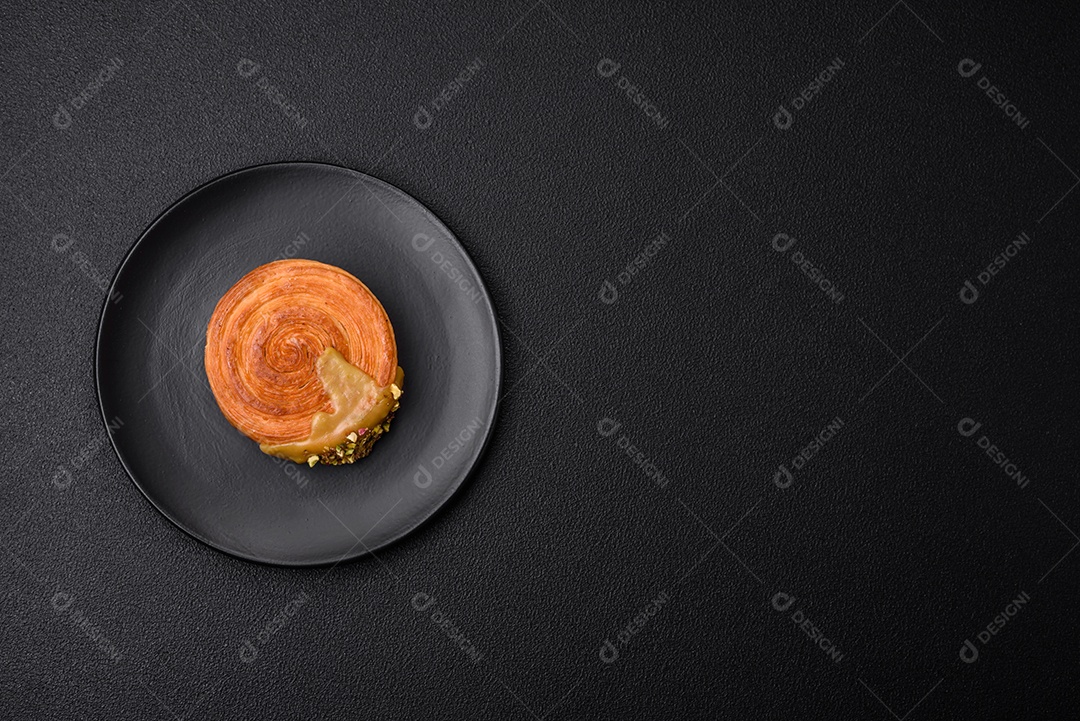 Croissant redondo de massa folhada com recheio de framboesa ou rolo de Nova Iorque sobre fundo escuro de concreto