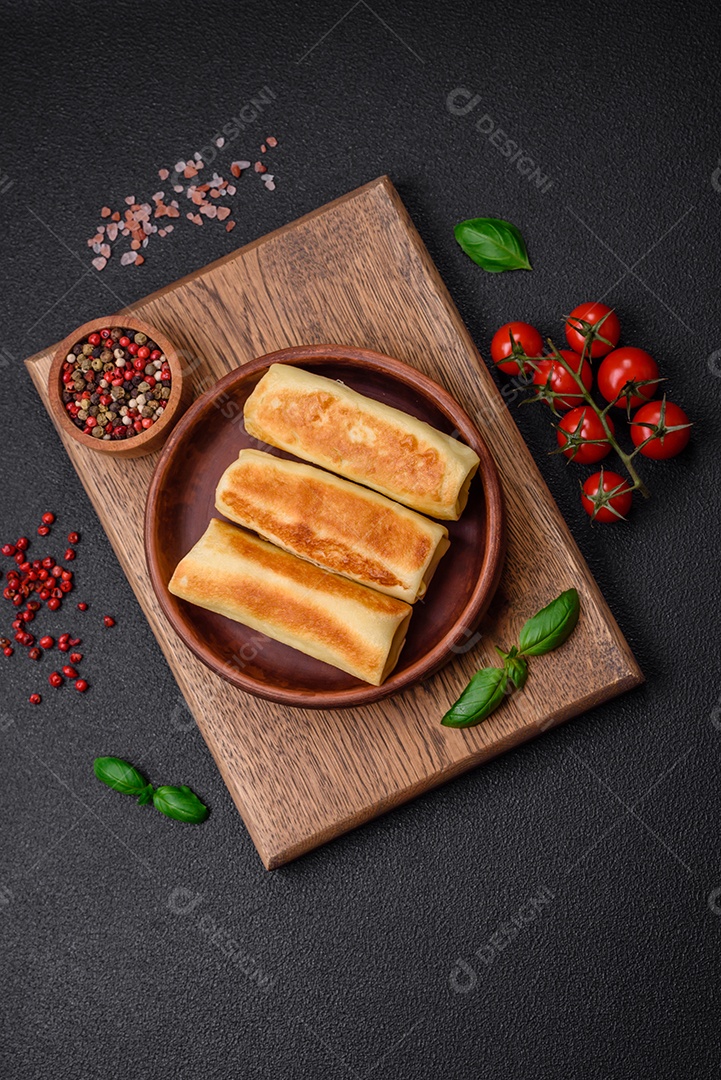 Deliciosas panquecas fritas caseiras frescas com brócolis e carne ou peixe com sal e especiarias sobre um fundo escuro de concreto