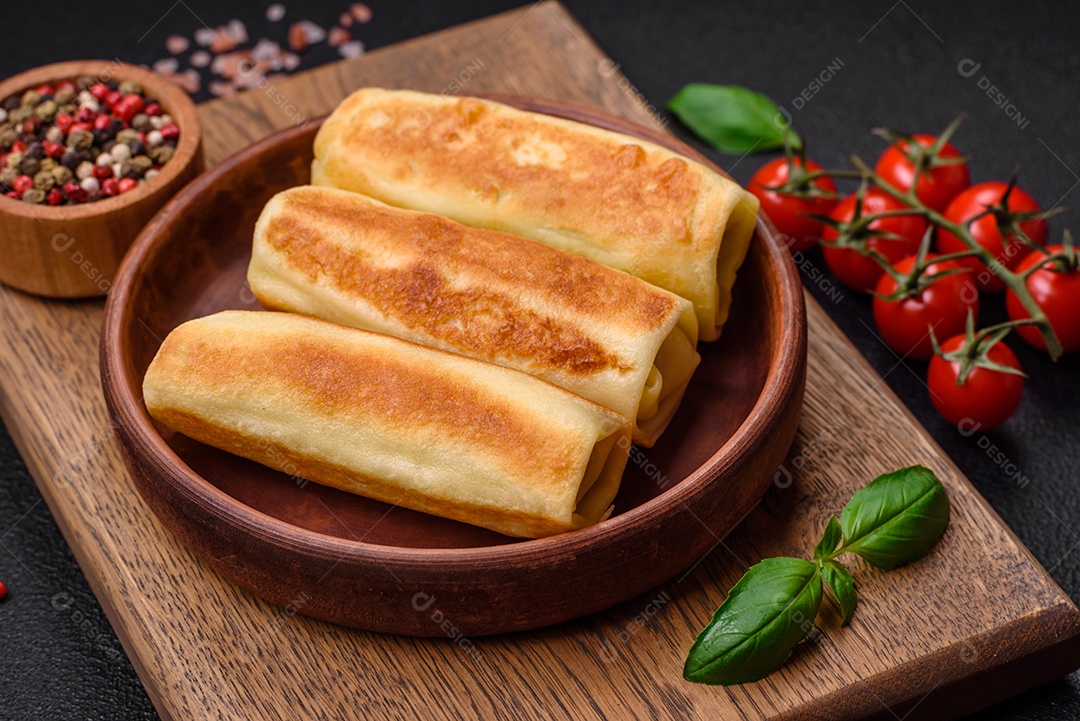 Deliciosas panquecas fritas caseiras frescas com brócolis e carne ou peixe com sal e especiarias sobre um fundo escuro de concreto