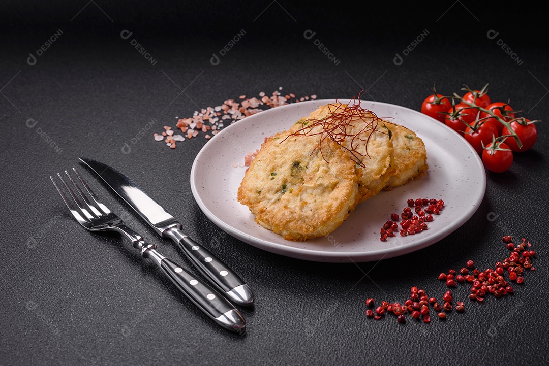 Deliciosas costeletas ou almôndegas fritas com sal, especiarias e ervas sobre um fundo escuro de concreto