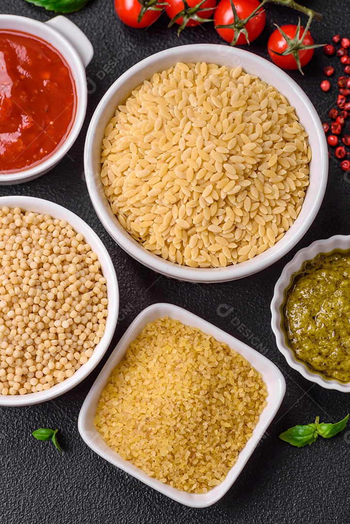 Massa orzo crua integral como ingrediente de um prato delicioso. Prato da cozinha mediterrânea