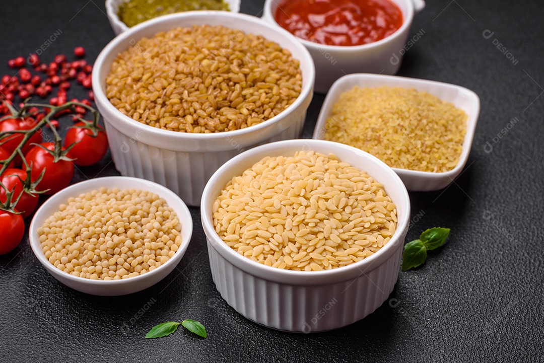 Massa orzo crua integral como ingrediente de um prato delicioso. Prato da cozinha mediterrânea