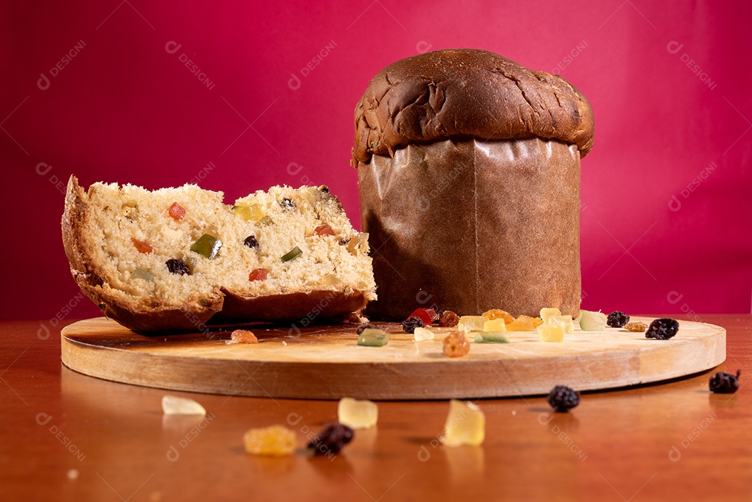 Panetone com frutas sobre tábua de madeira