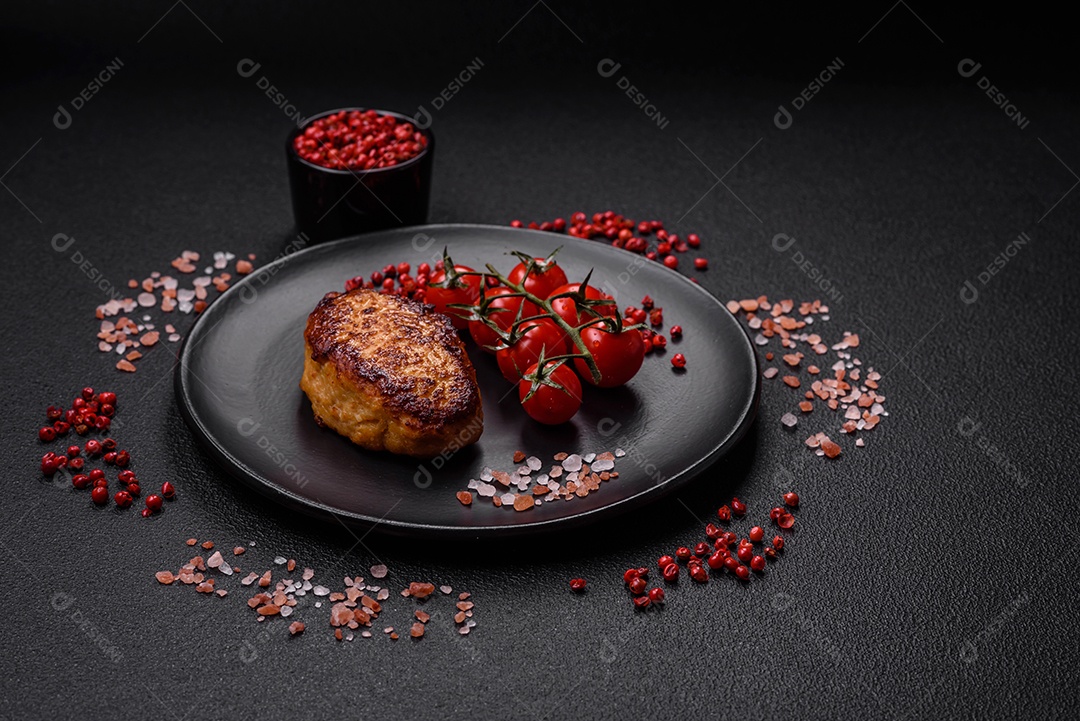 Deliciosa costeleta de soja vegetariana frita fresca com sal, especiarias e ervas com legumes em uma placa de cerâmica sobre um fundo escuro de concreto