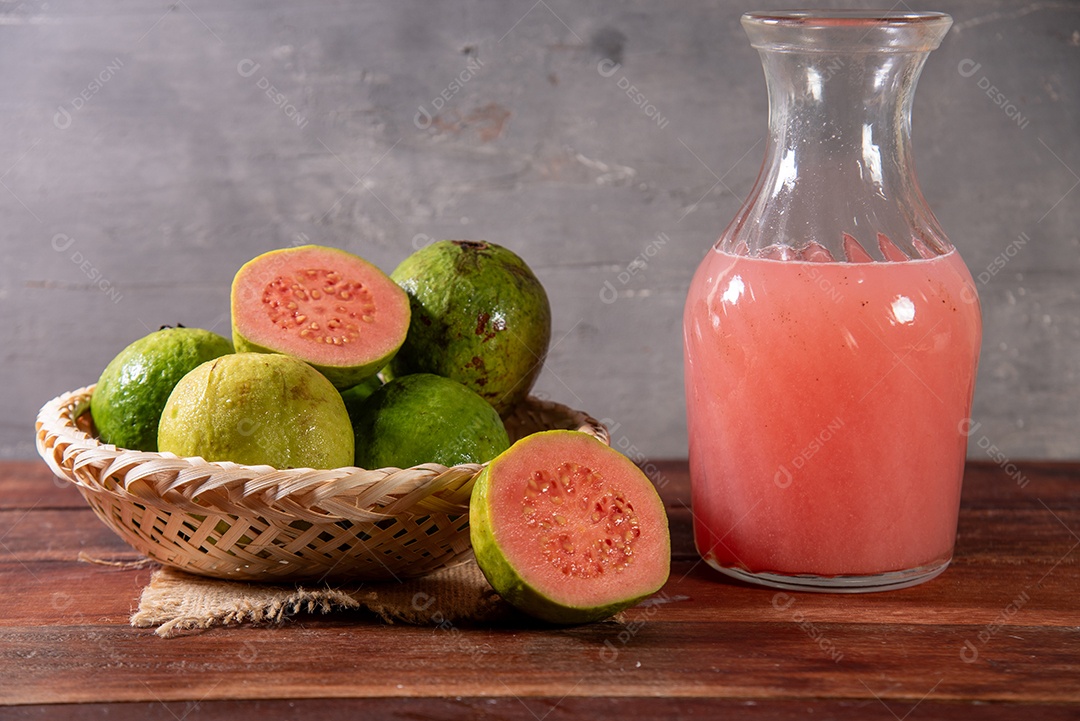 Tigela com goiabas e jarra com suco bem gelado