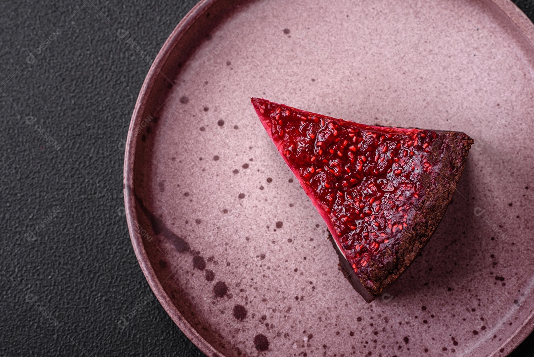 Delicioso bolo de cheesecake doce com queijo mascarpone, framboesas e geléia em um fundo escuro de concreto