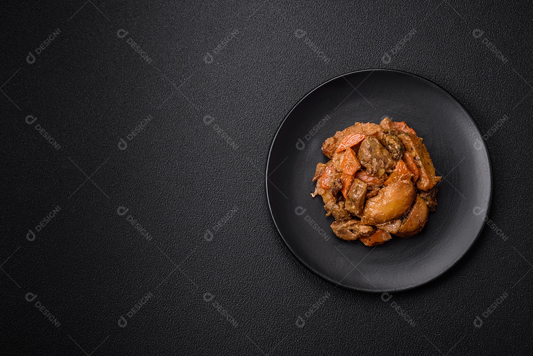 Deliciosa salada fresca com fatias de frango grelhado, abacaxi, pimentão, nozes e molho em um prato de cerâmica sobre um fundo escuro de concreto