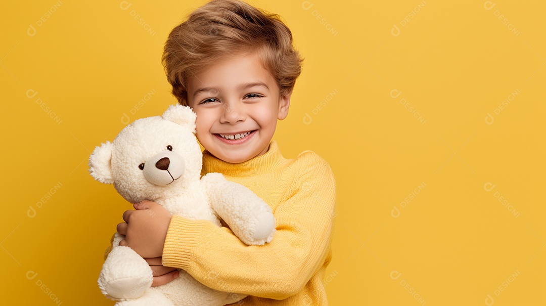 Garoto branco em roupas casuais se diverte, abraça o ursinho de pelúcia
