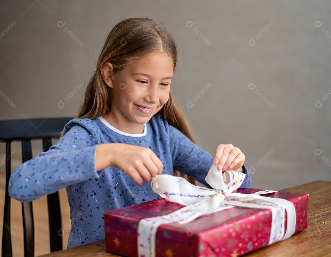 Linda garota jovem abrindo seu presente de natal