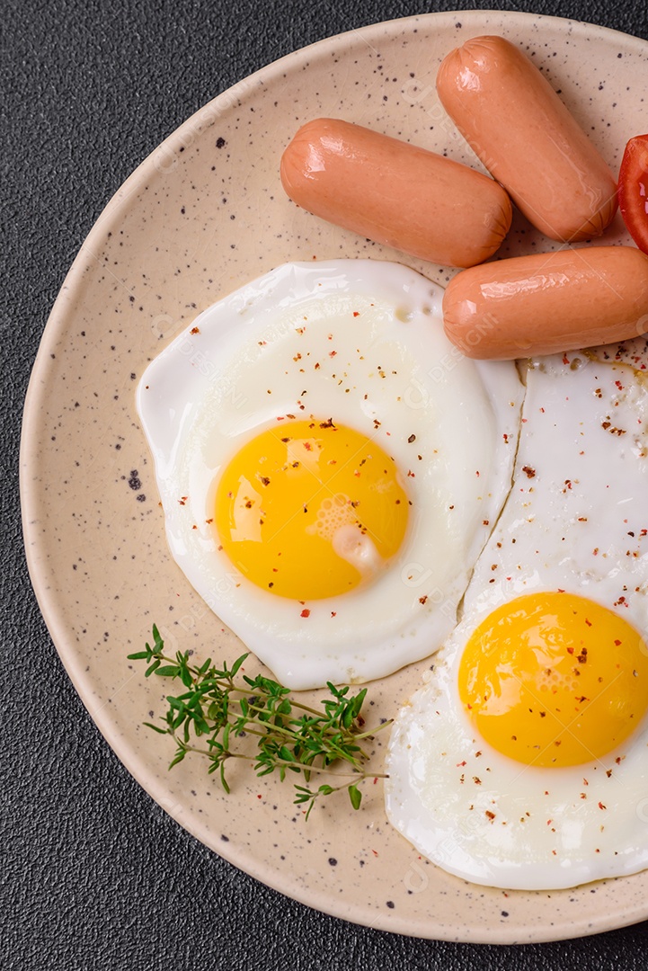 Ovos de galinha fritos, salsichas, tomate cereja, grão de bico, especiarias, sal e ervas. Delicioso café da manhã nutritivo