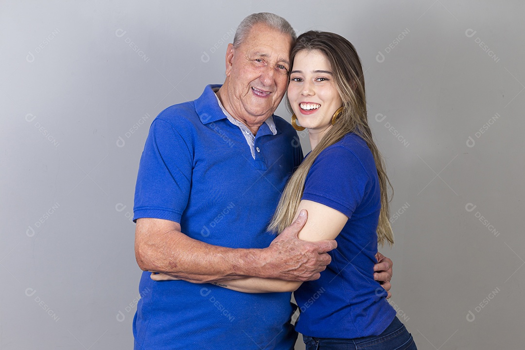 Homem idoso e jovem mulher combinando de camiseta azul