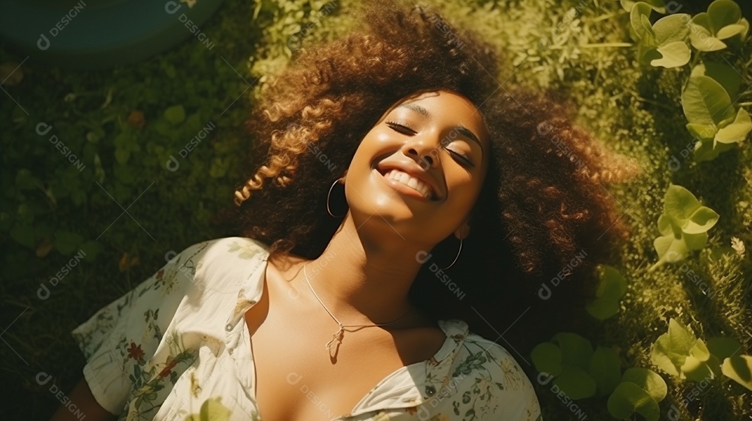 Sorridente jovem negra deitada na grama