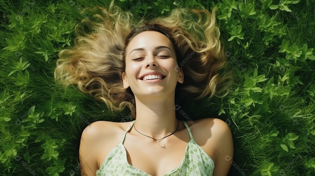 Mulher jovem sorridente, deitada na grama