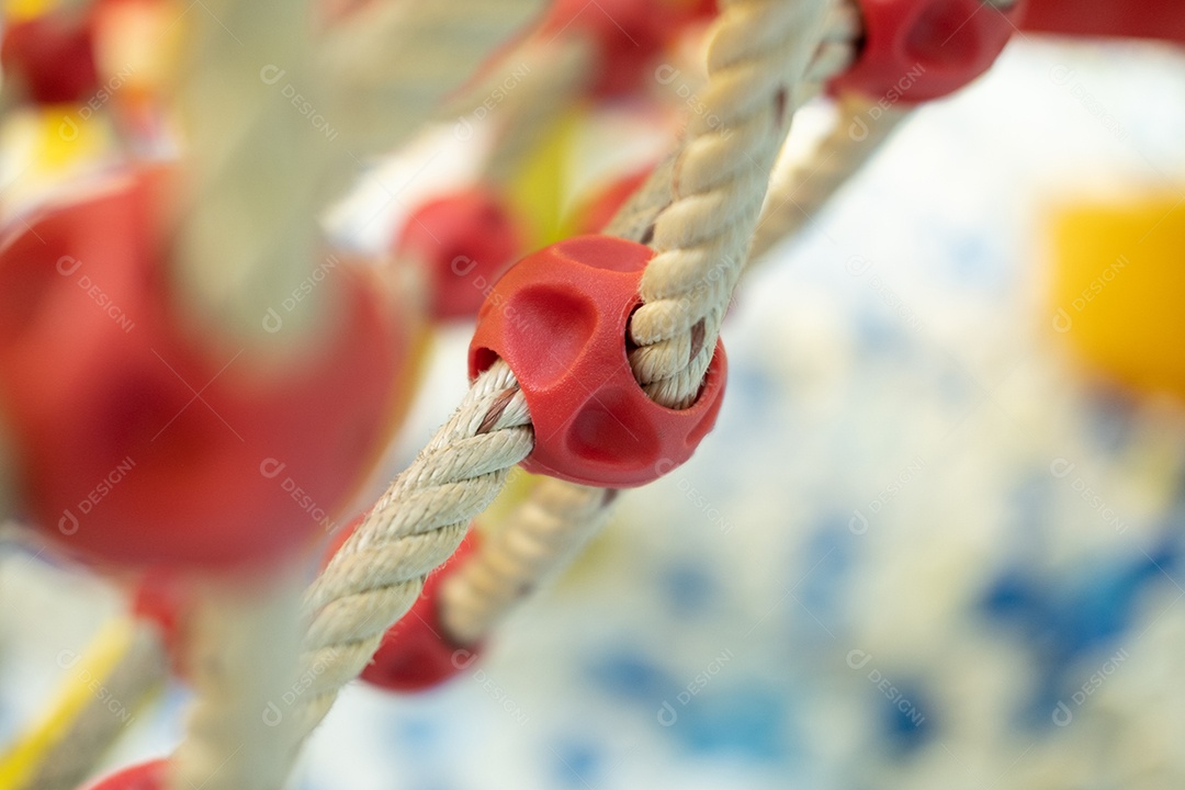 Rede de escalada em um parque infantil com pequenas bolas no chão