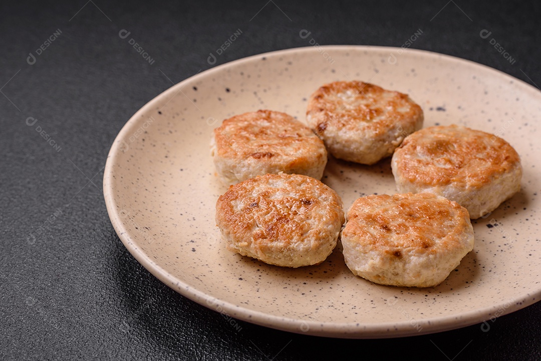 Almôndegas fritas de carne picada, carne de porco ou frango com sal, especiarias e ervas sobre um fundo escuro de concreto