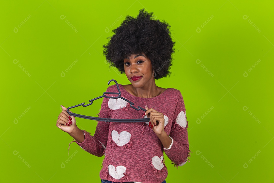 Linda jovem negra segurando cabide de roupas