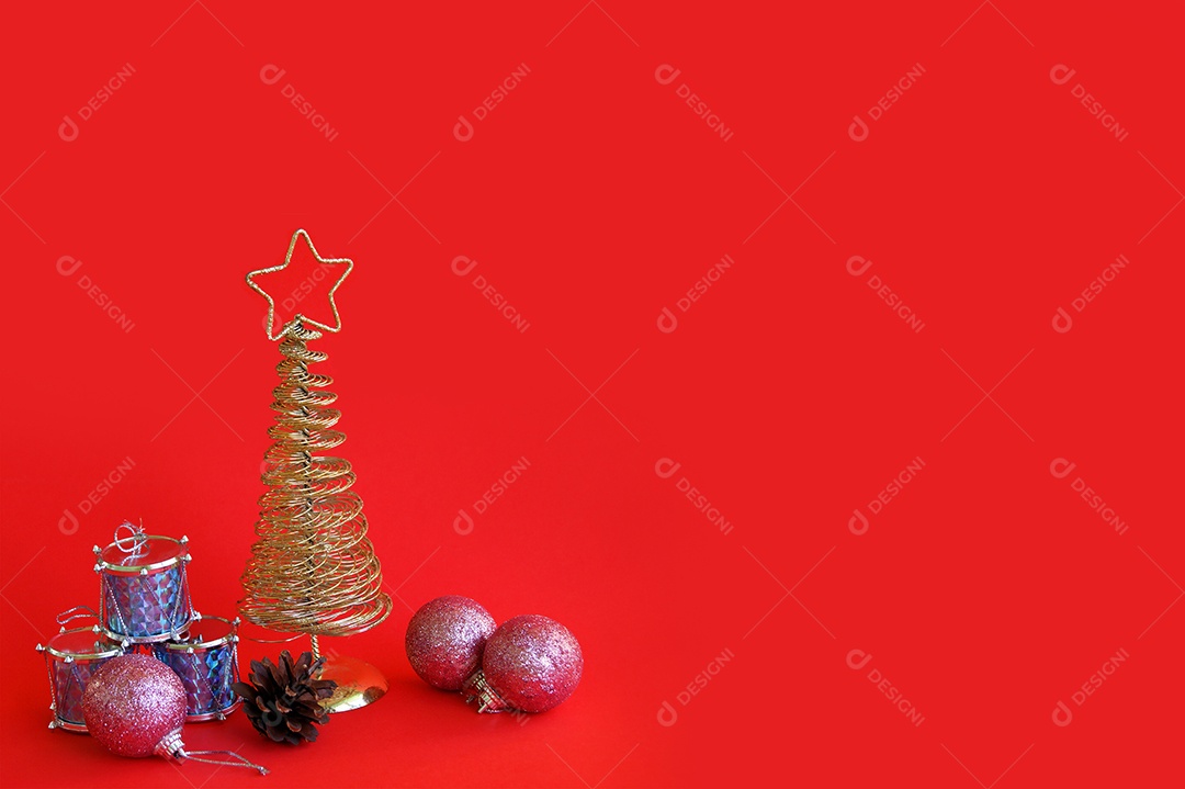 Árvore de natal com enfeites presentes ao lado em miniatura fundo vermelho