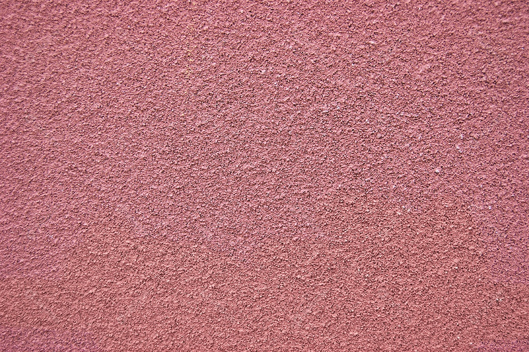 A parede horizontal rosa coberta com textura de gesso