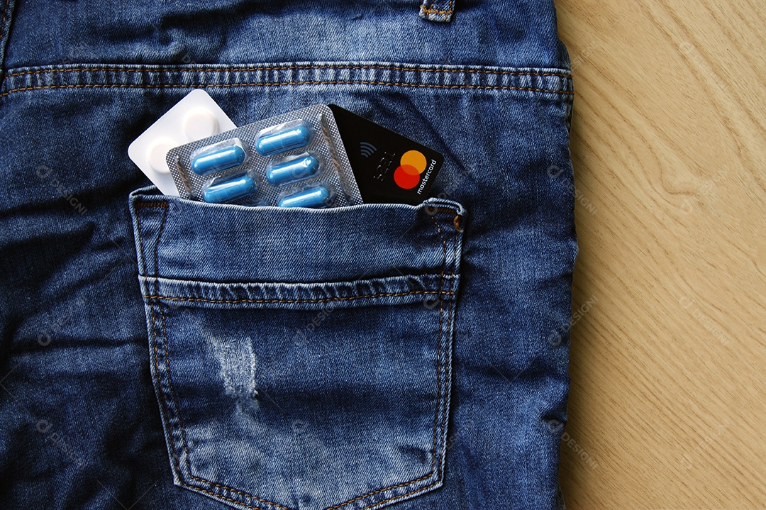 Comprimidos e cartão em bolso de trás de calça jeans