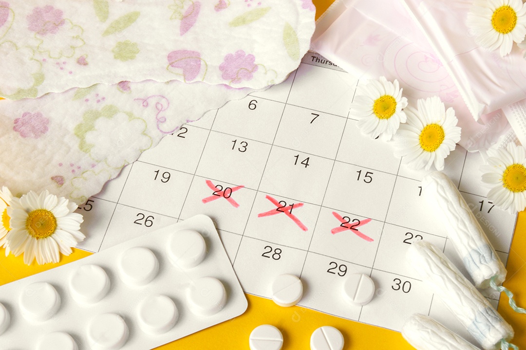 Calendário marcando período menstrual absorventes e comprimidos
