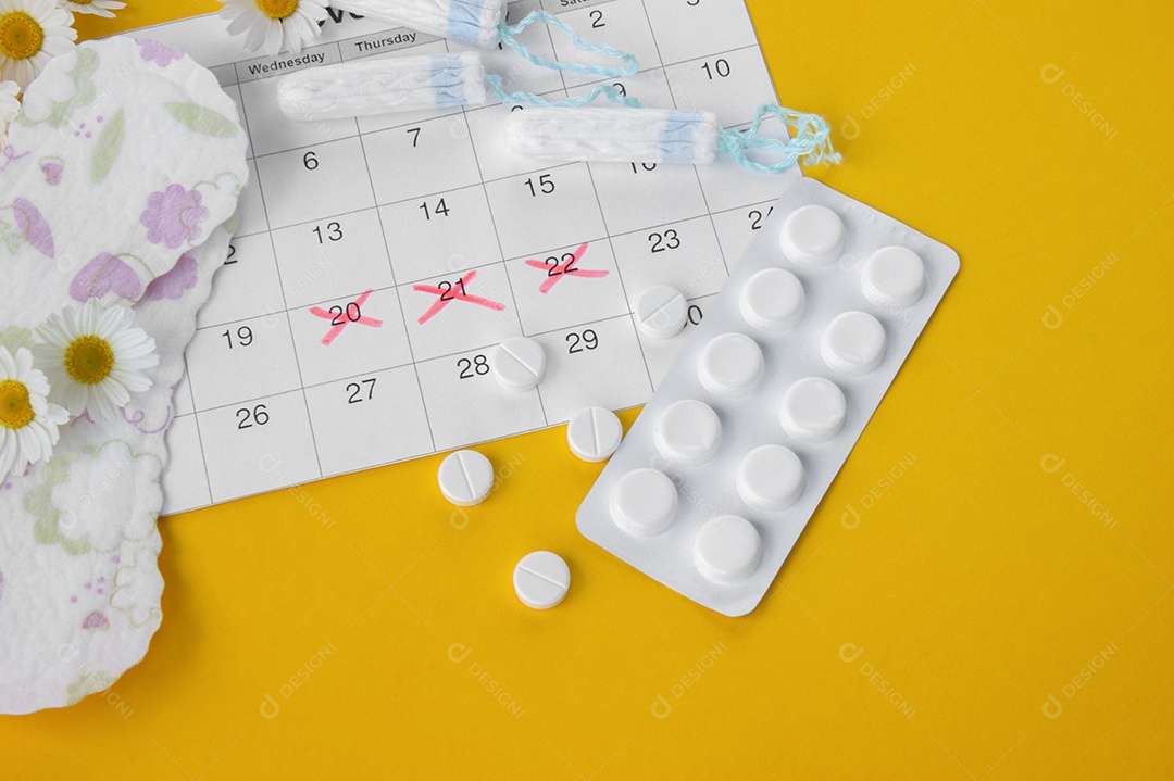 Calendário marcando período menstrual absorventes e comprimidos