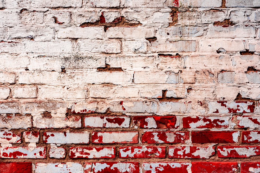 Textura de uma parede de tijolos com rachaduras e arranhões que podem ser usadas como fundo