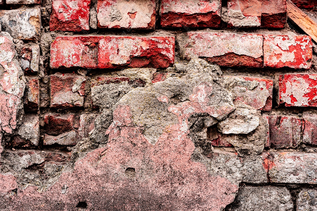 Textura de uma parede de tijolos com rachaduras e arranhões que podem ser usadas como fundo