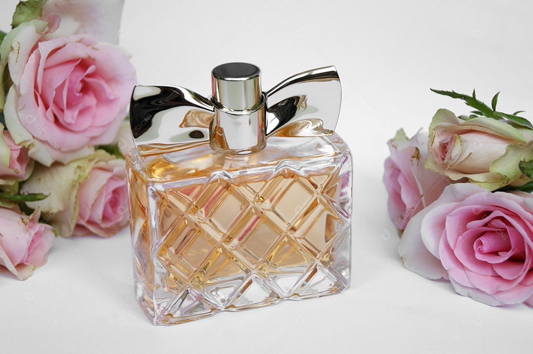 Frasco de perfume com flores ao lado