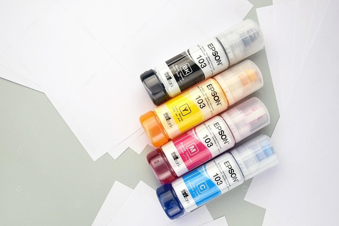 Quatro frascos de tinta Epson amarelo vermelho azul preto integrados a uma impressora