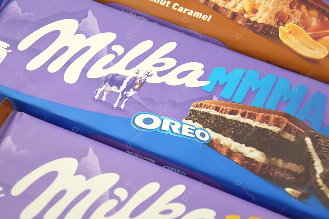 Marca de chocolate Milka com sabores Oreo e caramelo amendoim sobre fundo rosa suave