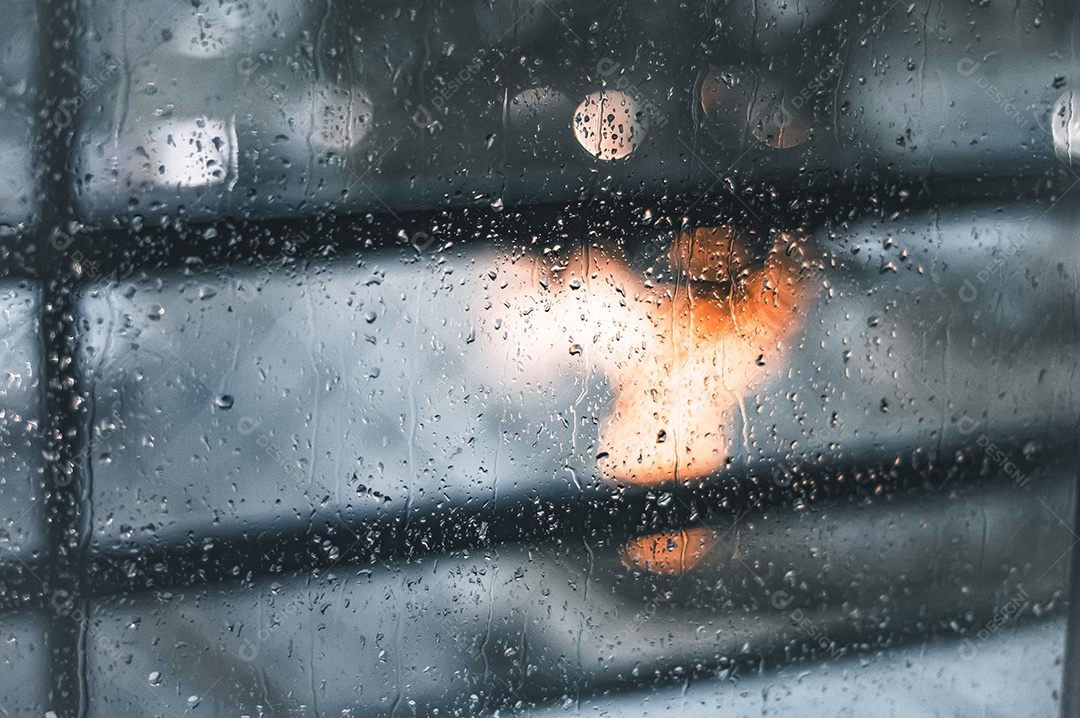 Pingos de chuva em vidro com árvore de Natal desfocada no fundo, luzes desfocadas, conceito de chuva