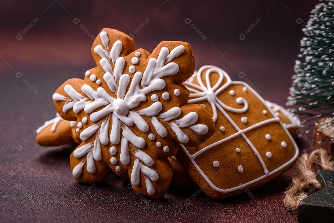 Lindos e deliciosos biscoitos de gengibre de Natal de inverno em um fundo texturizado de bronze.