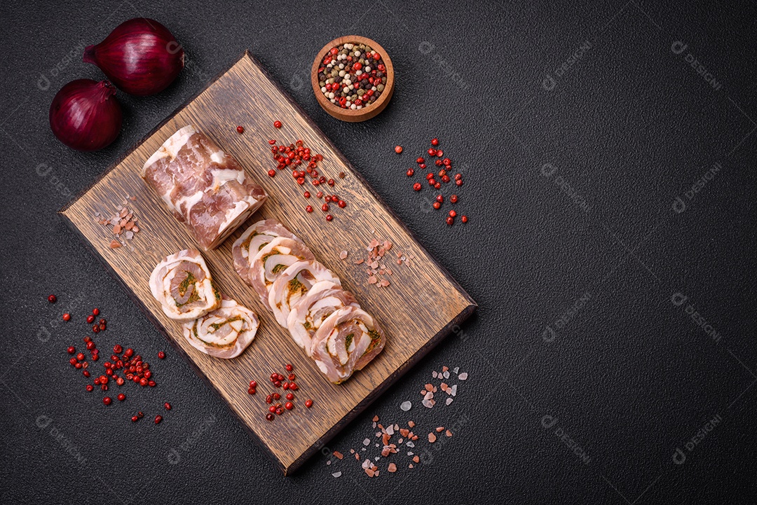 Bolo de carne delicioso com banha, sal, especiarias e ervas cortadas em fatias sobre um fundo escuro de concreto