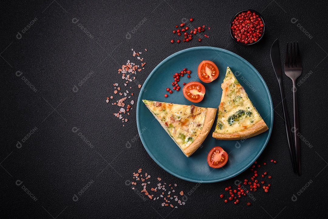 Deliciosa quiche com brócolis, queijo, frango, especiarias e ervas sobre um fundo escuro de concreto